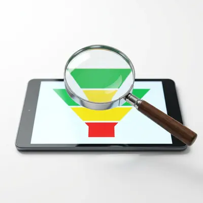 Magnifying glass examining a CRM sales funnel on a tablet screen